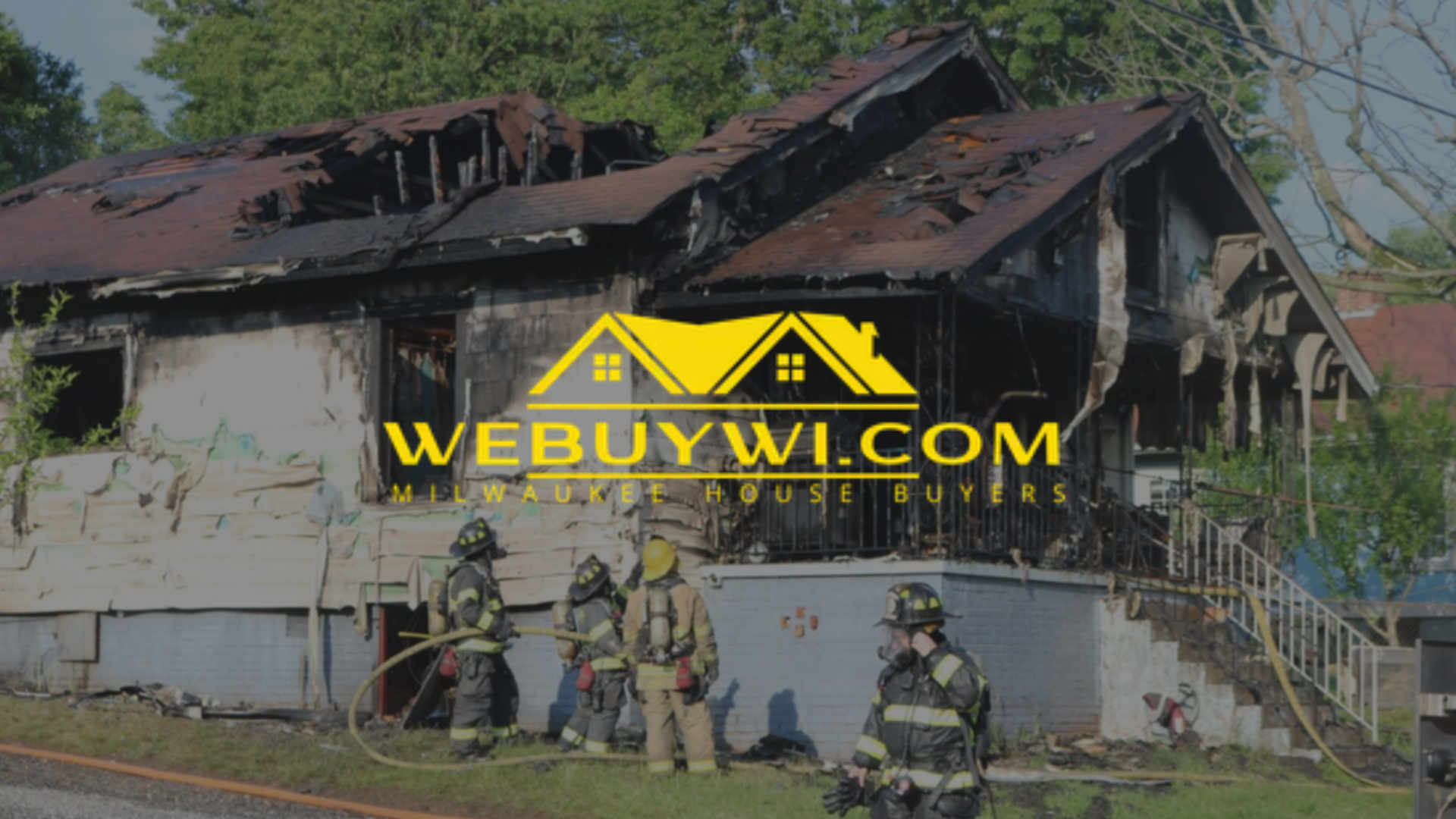 Firefighters battling a house fire; severely damaged house with a 