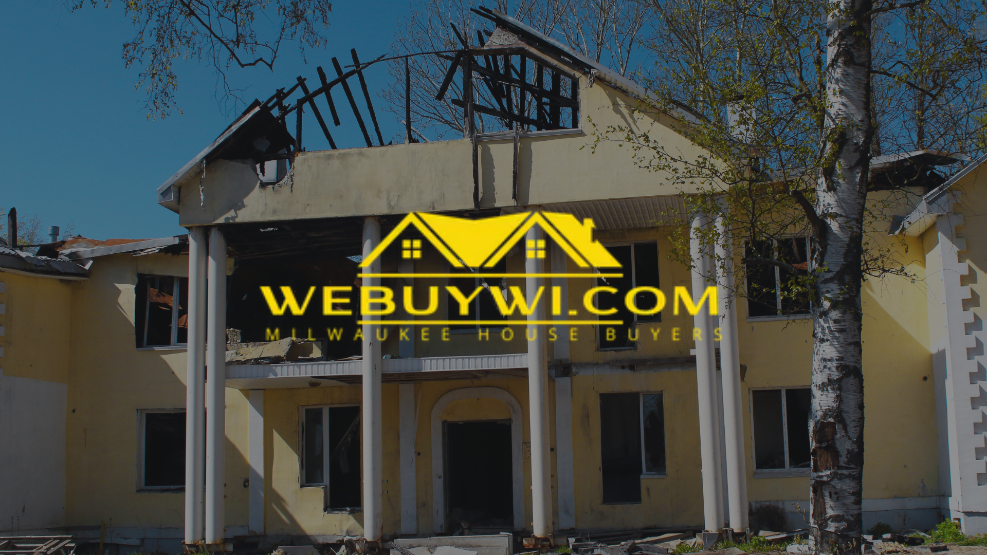 Damaged yellow house with missing roof;