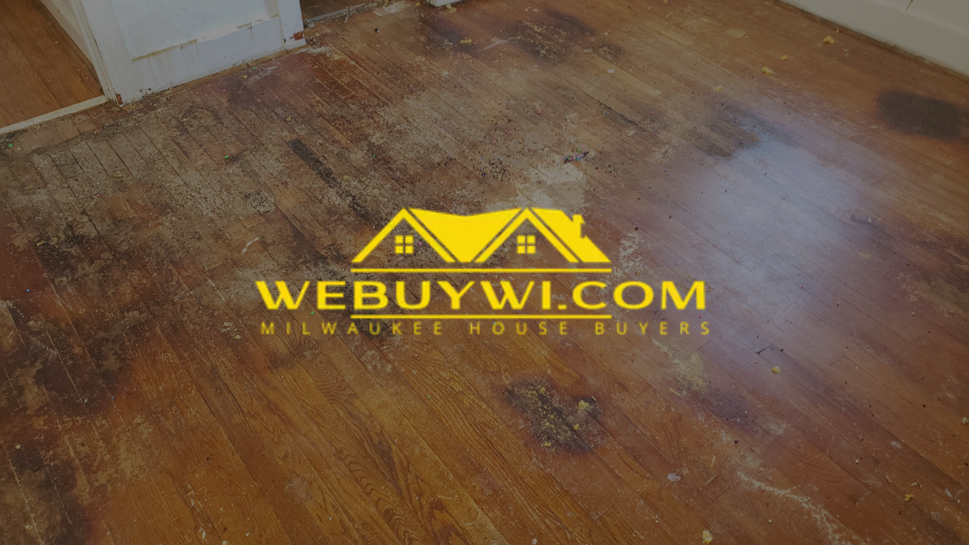 A wooden floor with a webuywi.com logo on it. symbolizing water damage in waukesha with webuywi.com logo overlaid on top