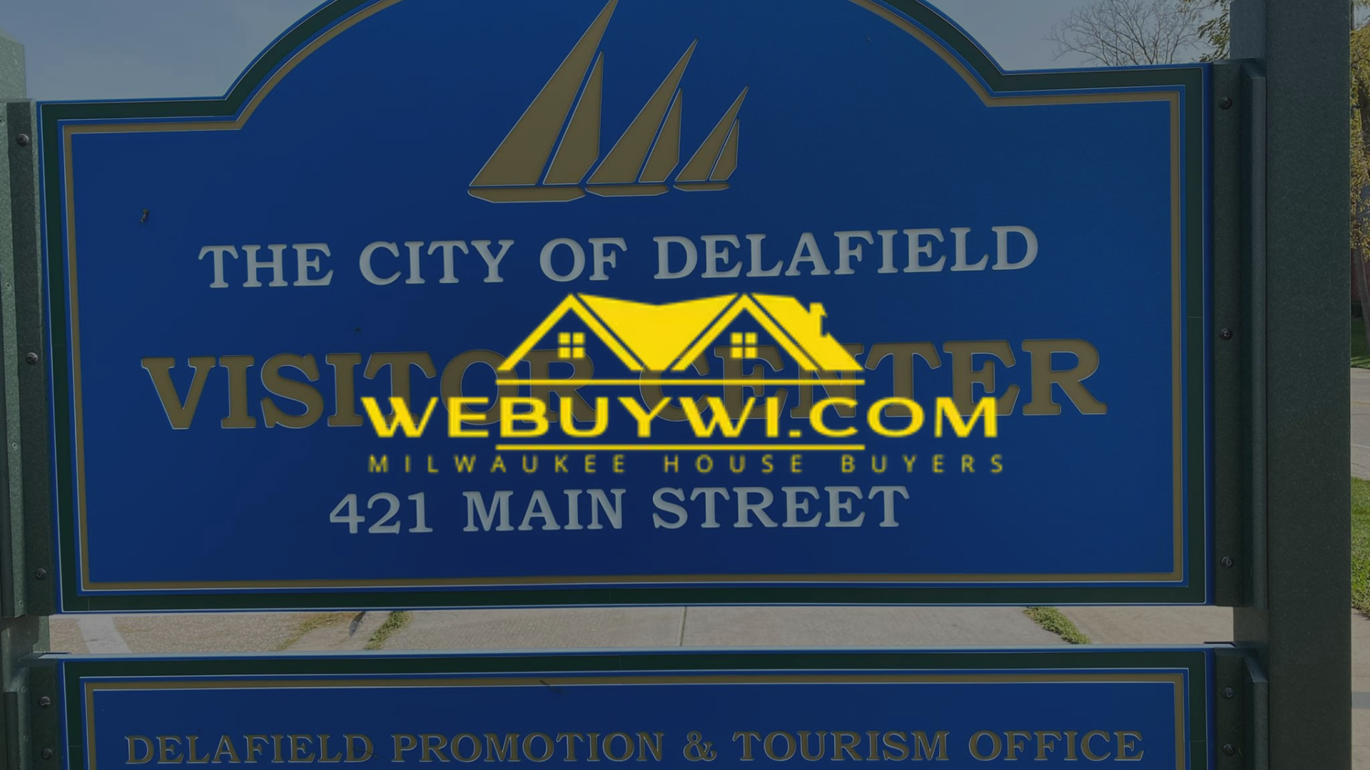 A blue sign that says the city of delafield on it