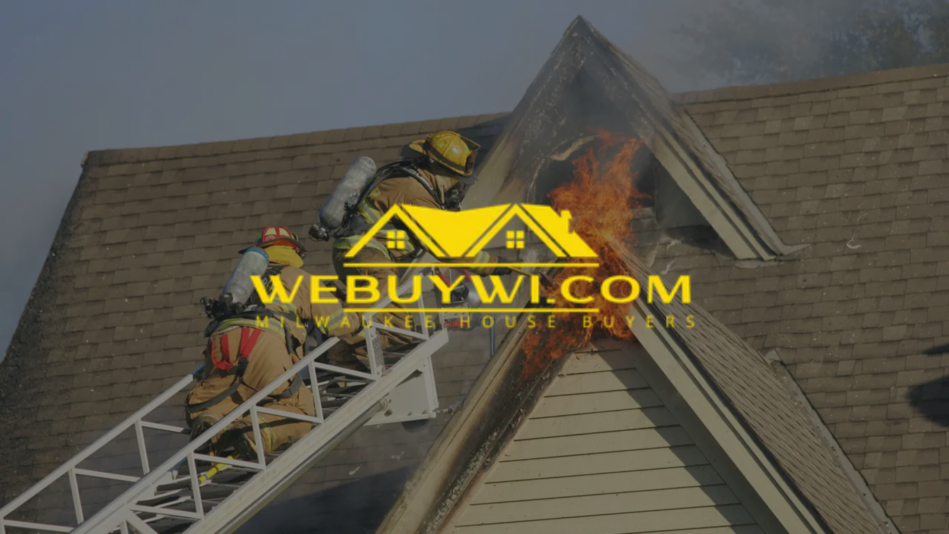 Firefighters on ladder battling a house fire; flames visible at the roof.
