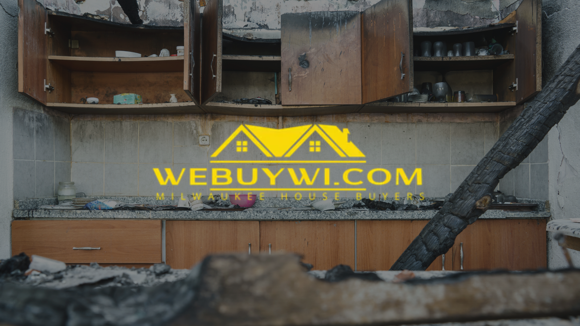 Burnt kitchen with open cabinets. A logo for