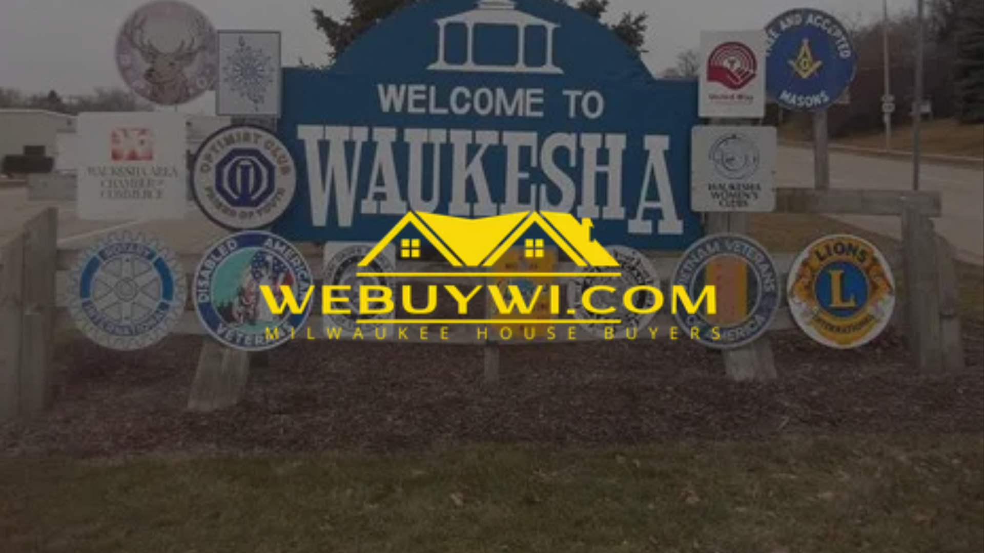 Welcome sign to Waukesha, WI, with webuywi.com logo overlaid. Surrounding emblems include logos for organizations.