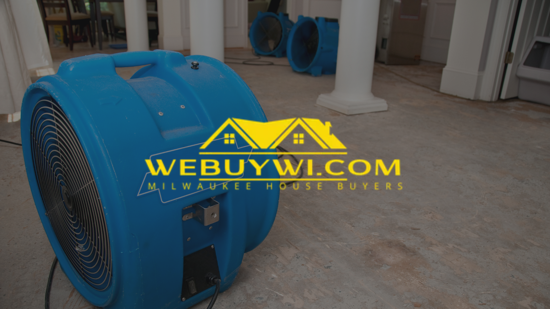 Blue air mover fan on a concrete floor indoors. Used for drying, with a webuywi.com logo on the image.