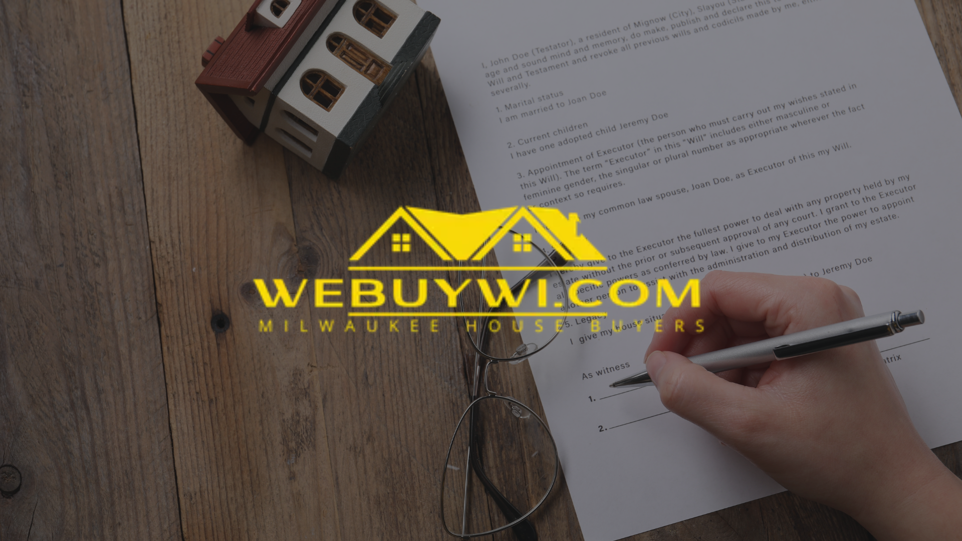 A person signing a document on a wooden table, next to a miniature house model. Logo for WeBuyWI.