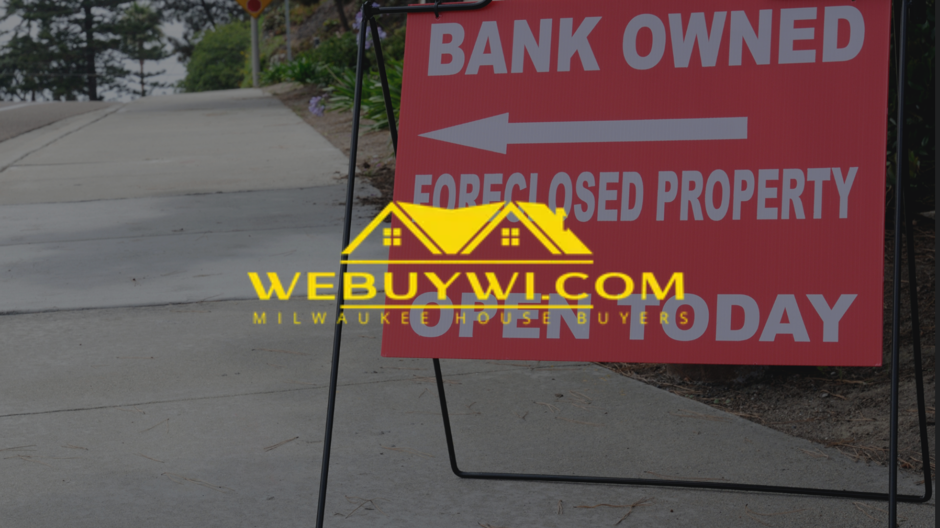 A red sign that says bank owned and foreclosed property with webuywi.com logo on top