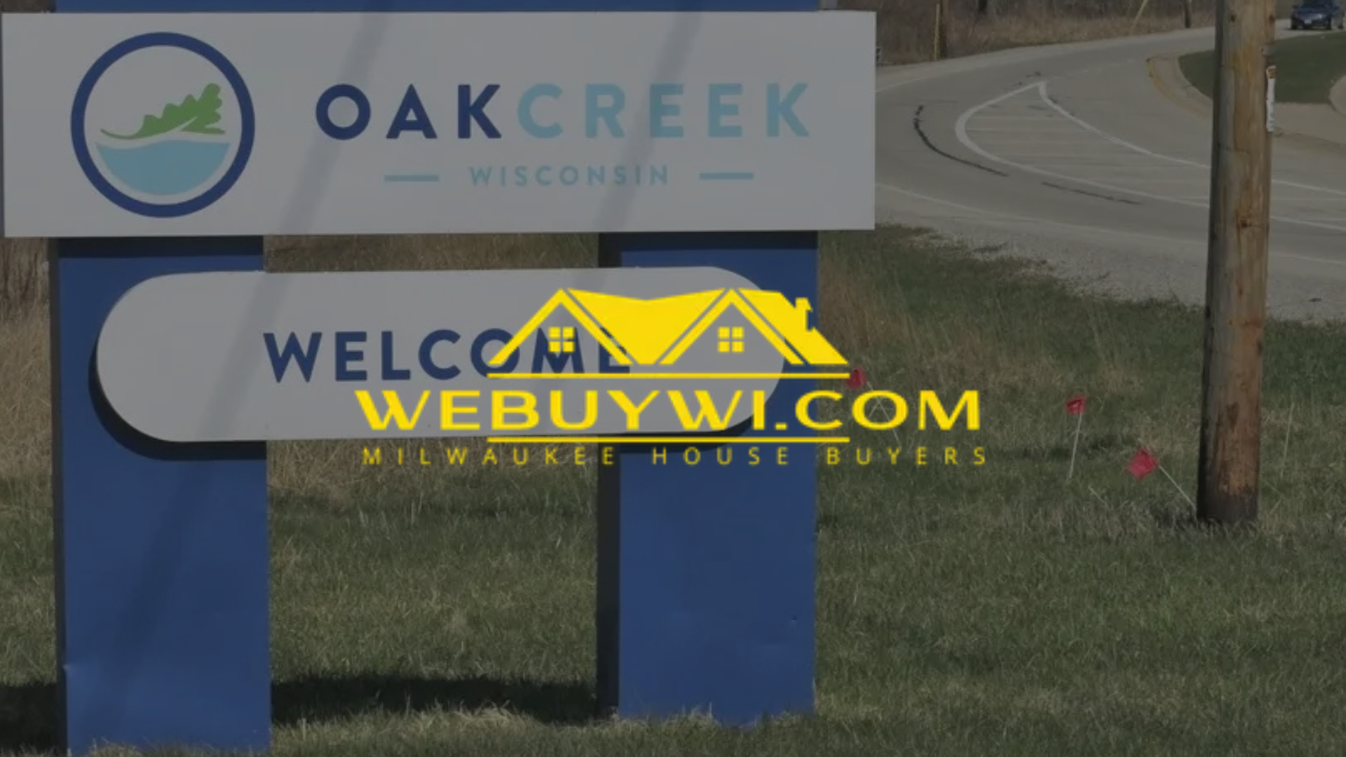 Sign for Oak Creek, Wisconsin, with a WeBuyWI.com advertisement.