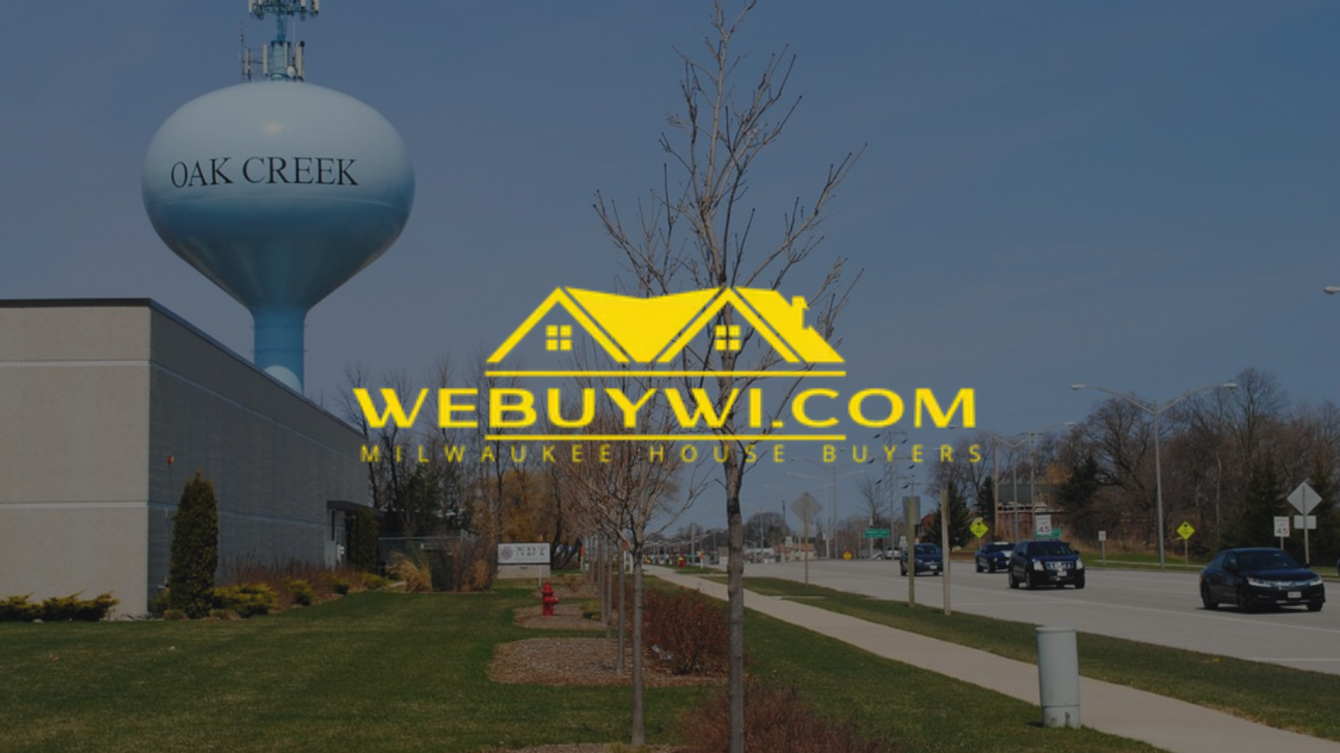 Water tower in Oak Creek, Wisconsin, next to a building and road, logo for