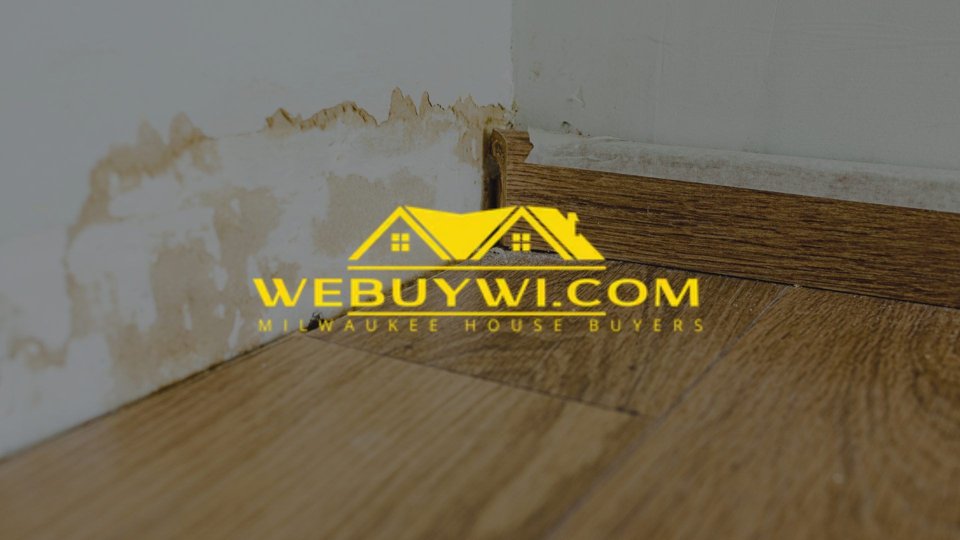 A corner of a room with a wooden floor and a white wall symbolizing water damage with webuywi.com logo on top