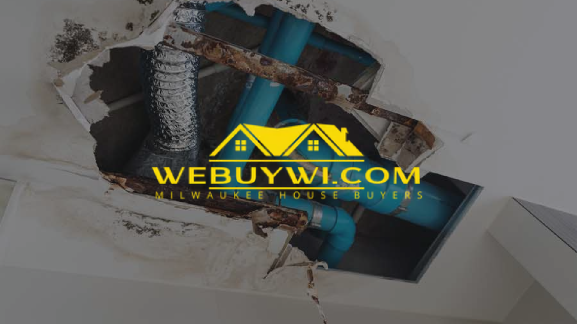 Hole in greenfield wi house ceiling reveals rusty pipes and water damage, with 