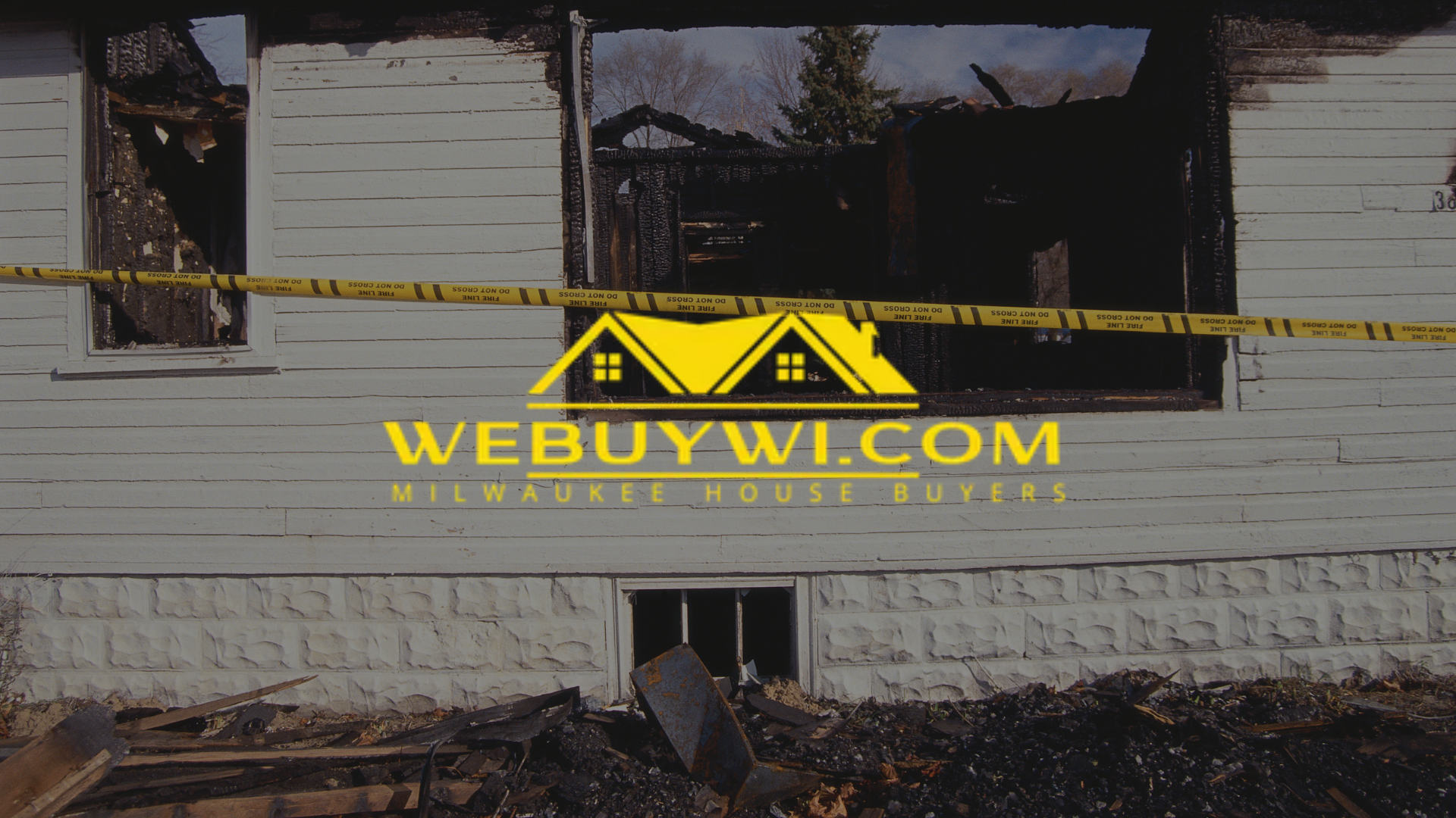 white fire damaged house with webuywi logo overlaid on top