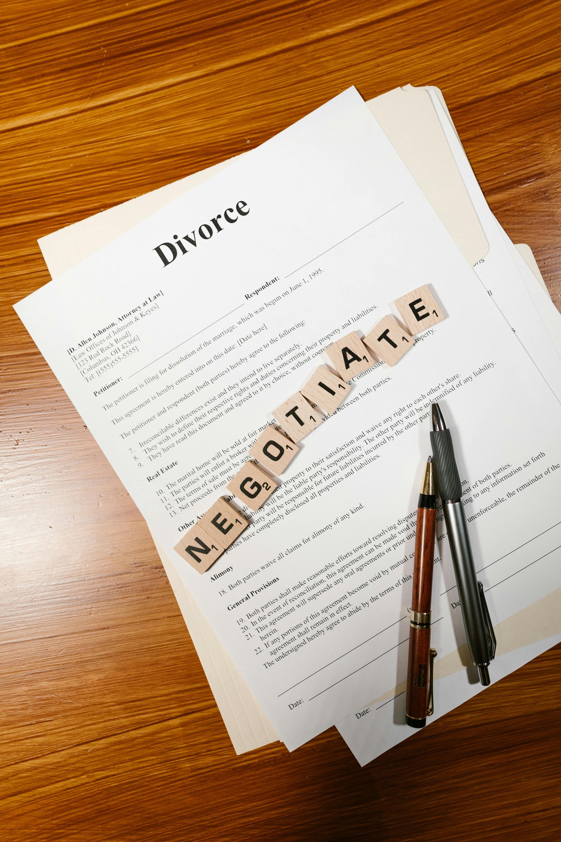 Divorce papers with Scrabble tiles spelling 