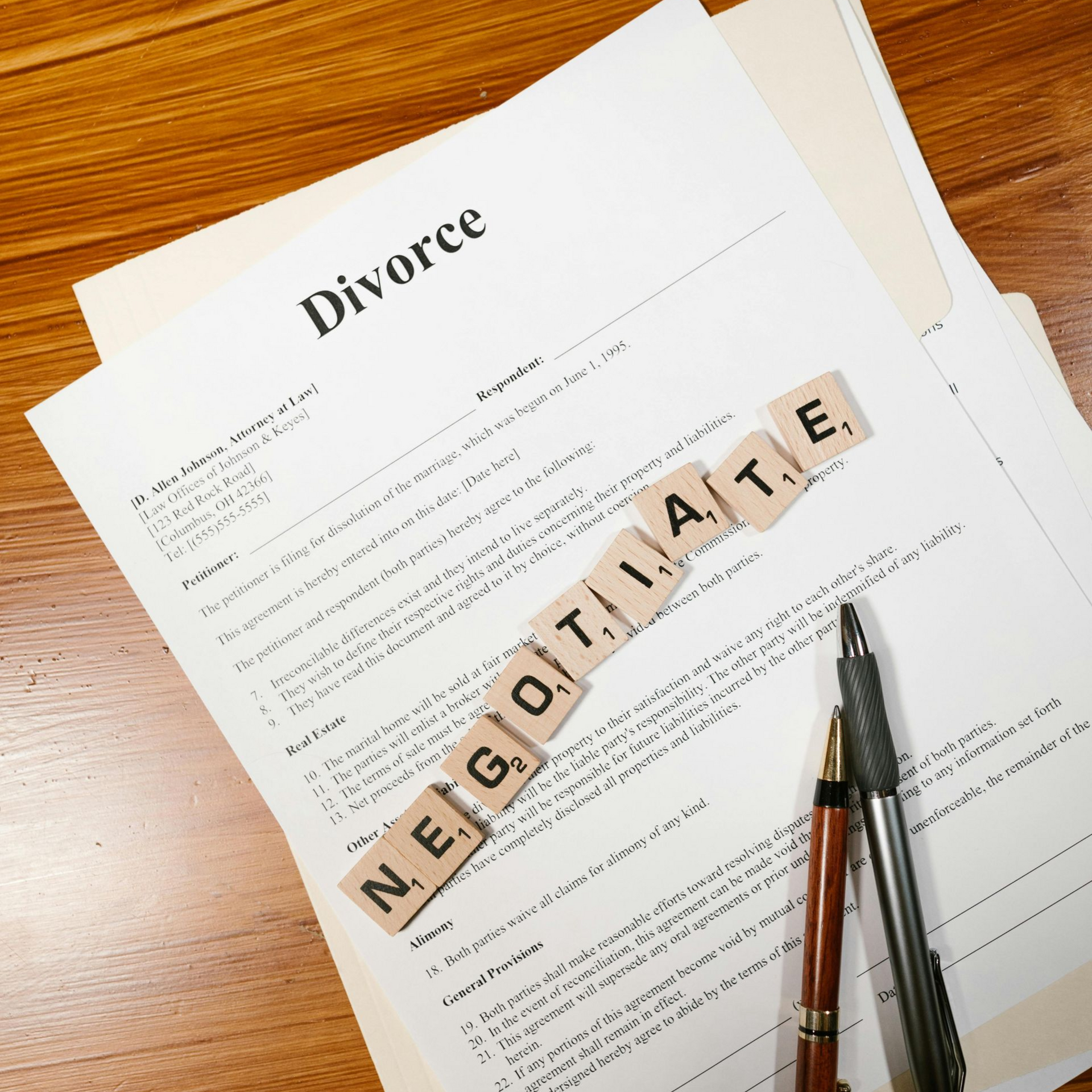 Divorce document on a wooden table with a pen.
