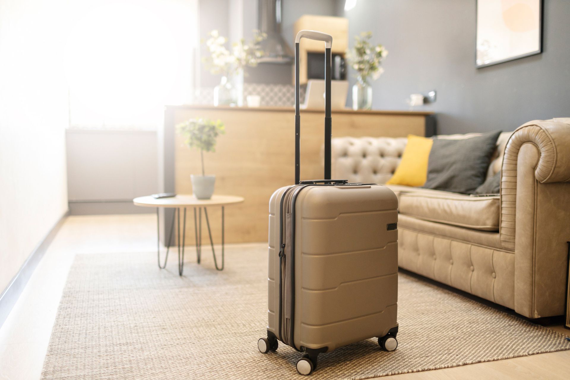 A suitcase is sitting on the floor in a living room next to a couch.