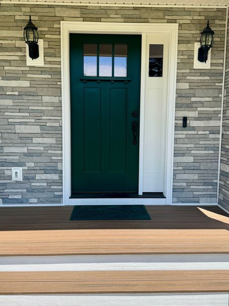 The front door of a house with a green door