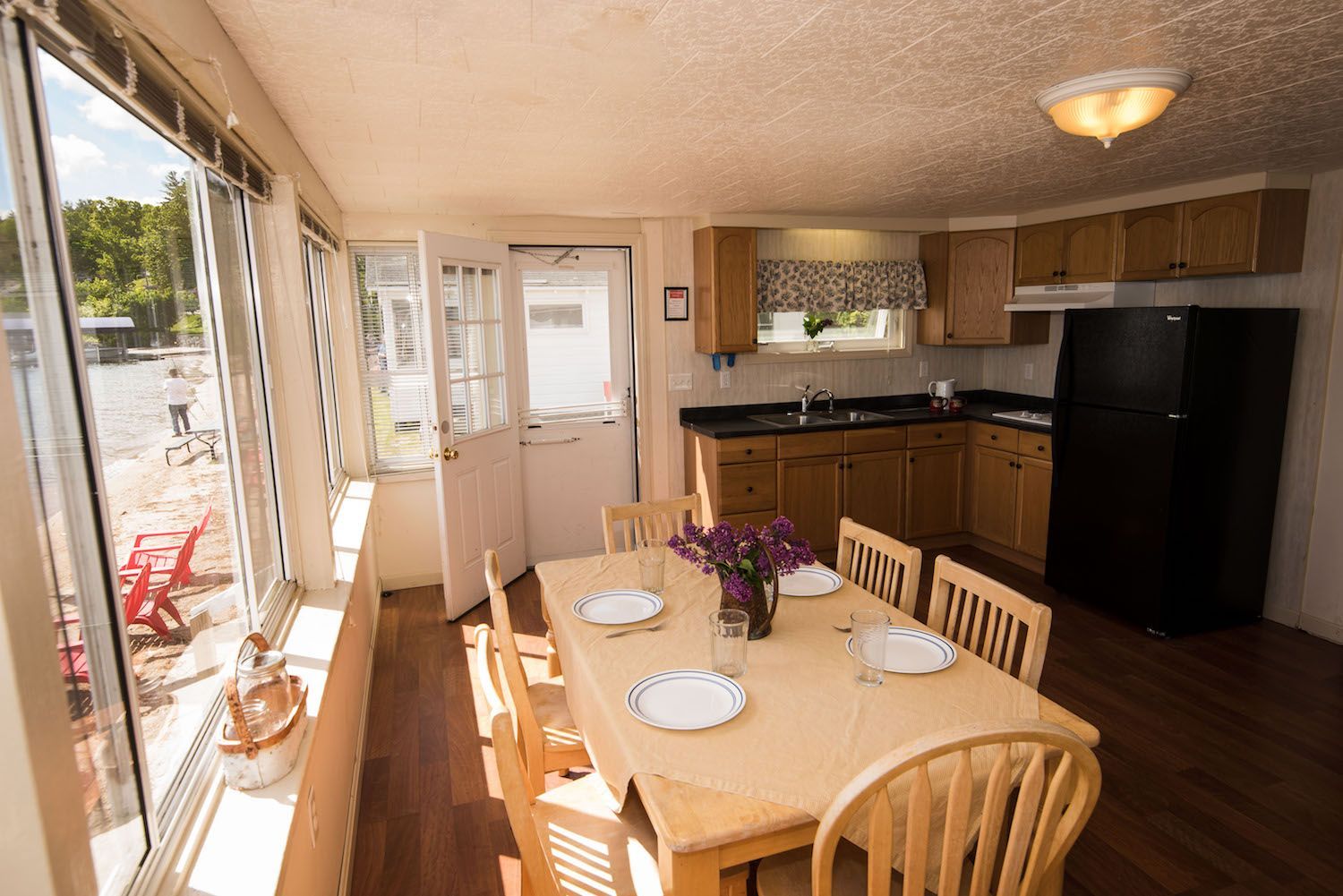 A kitchen with a table and chairs and a refrigerator.