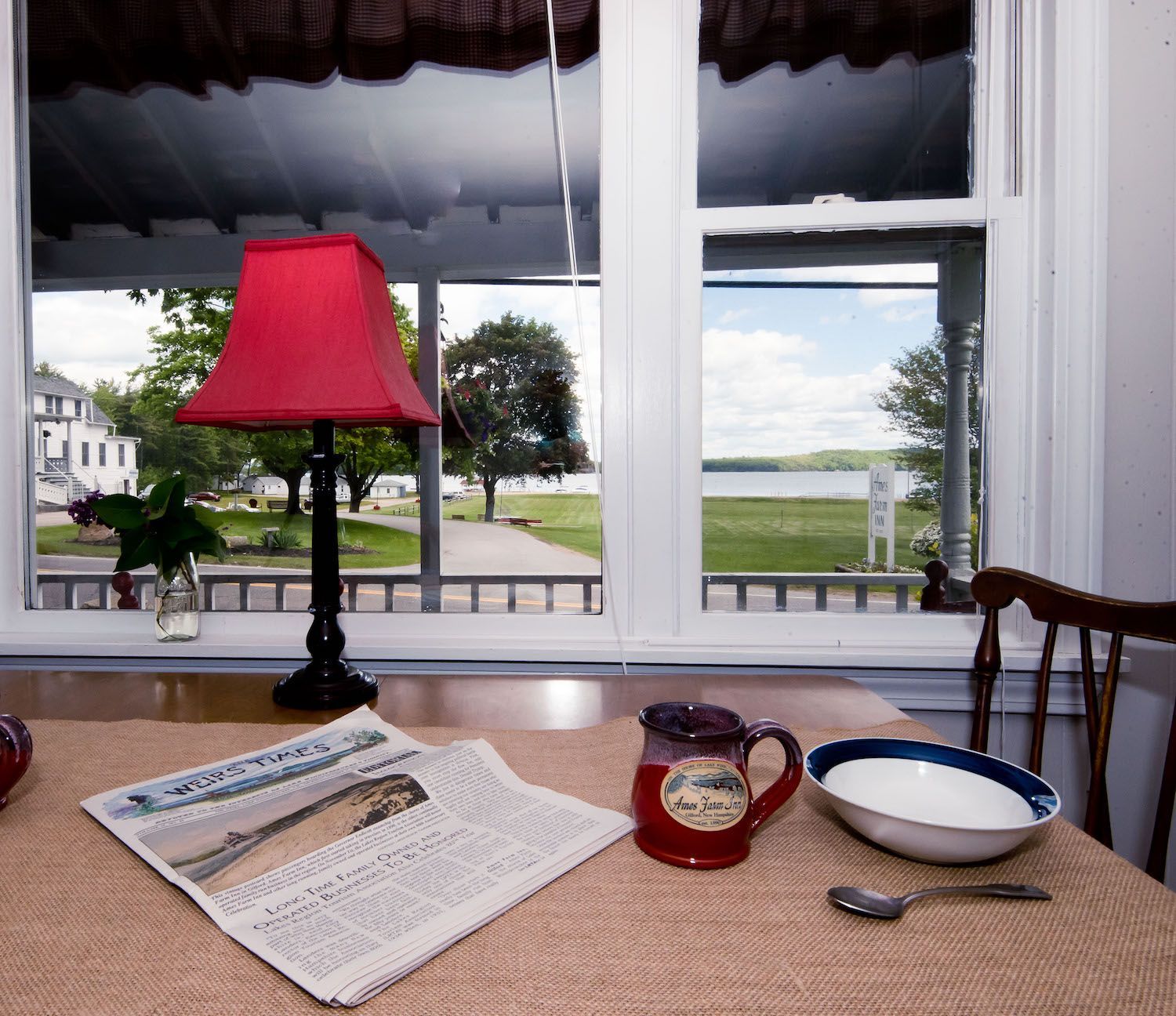 A table with a newspaper and a bowl on it