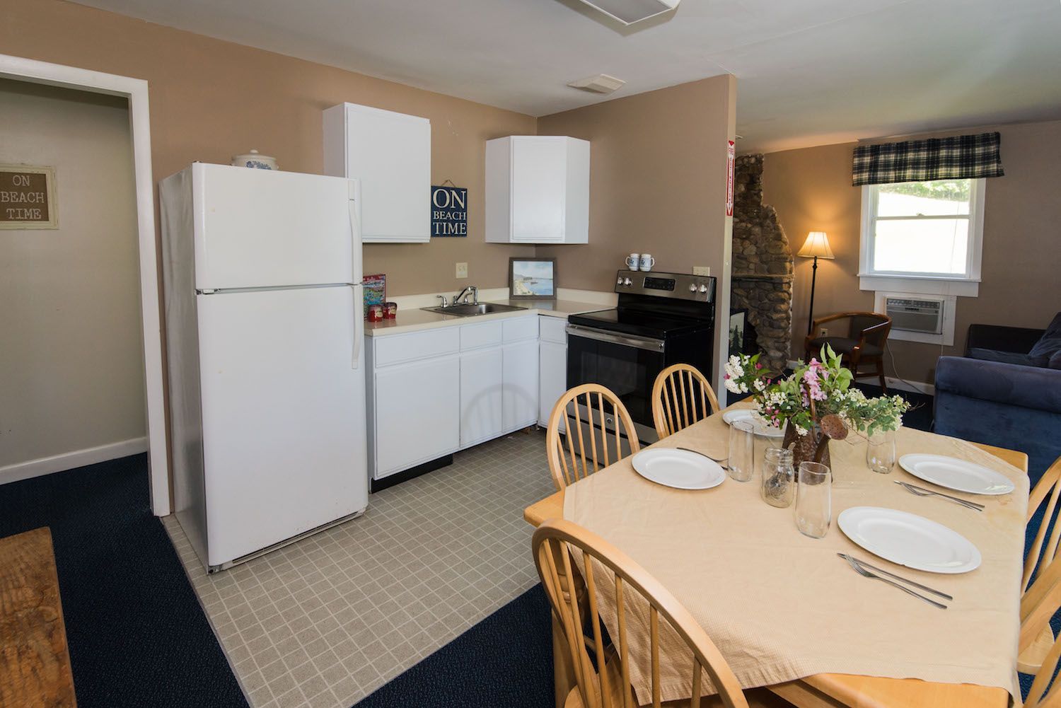 A kitchen with a table and chairs and a refrigerator