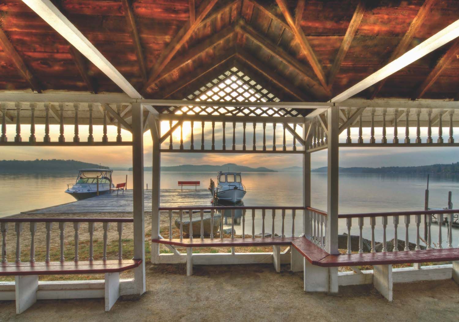 A gazebo overlooking a body of water with boats in it