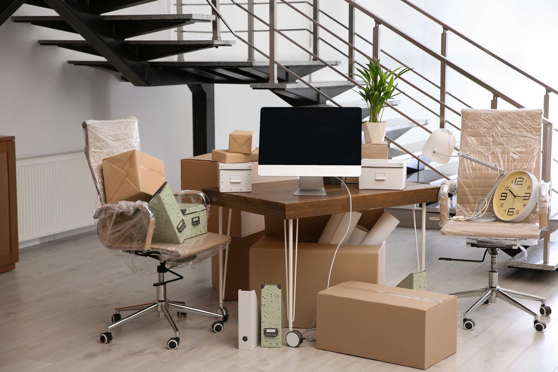 an office filled with boxes and a computer on a desk