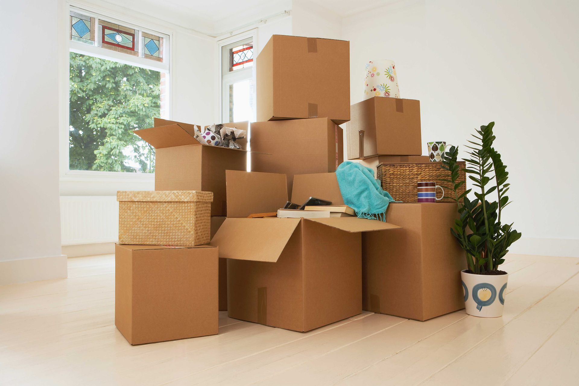 a bunch of cardboard boxes are stacked on top of each other in an empty room