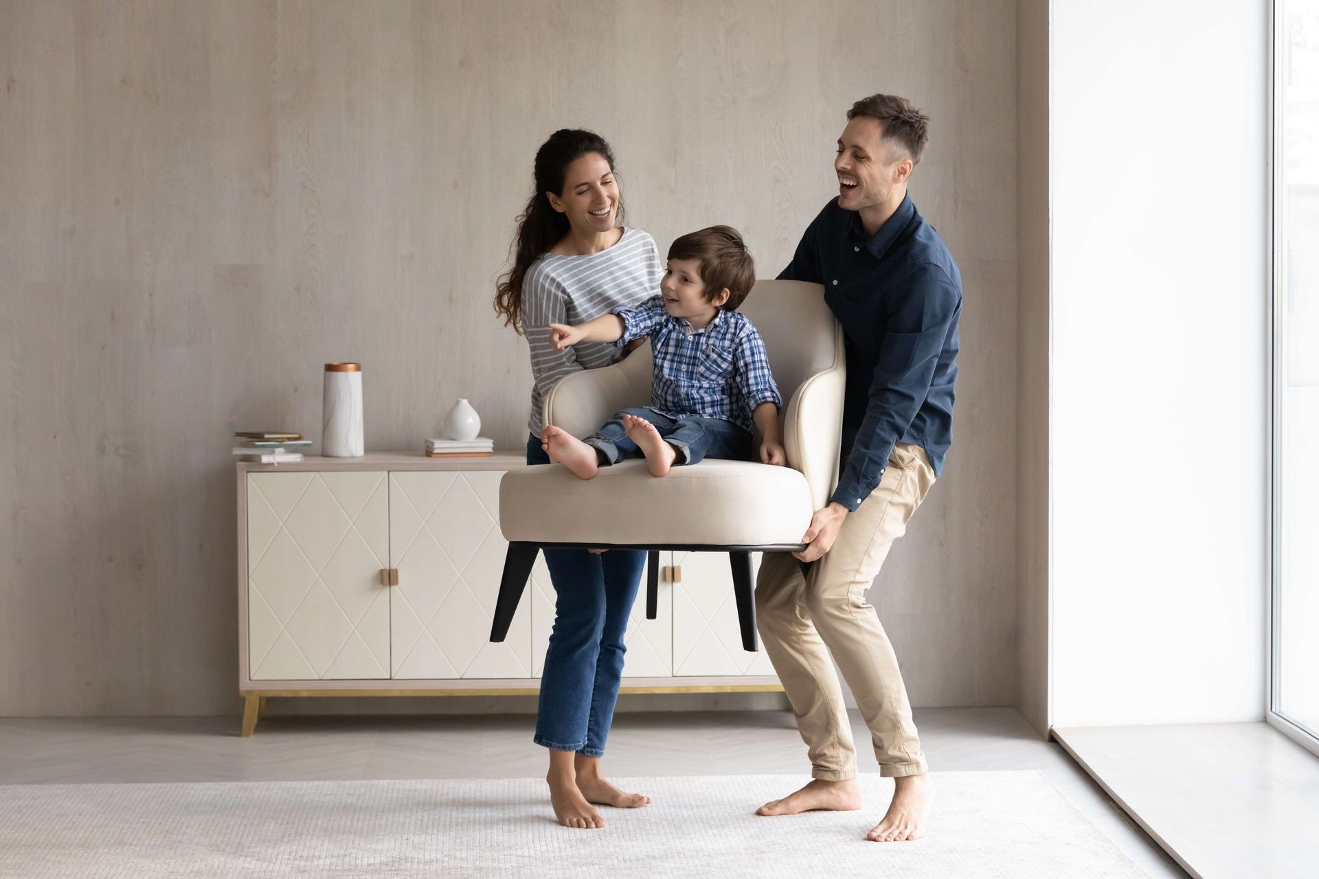 a family is playing with a chair in a living room