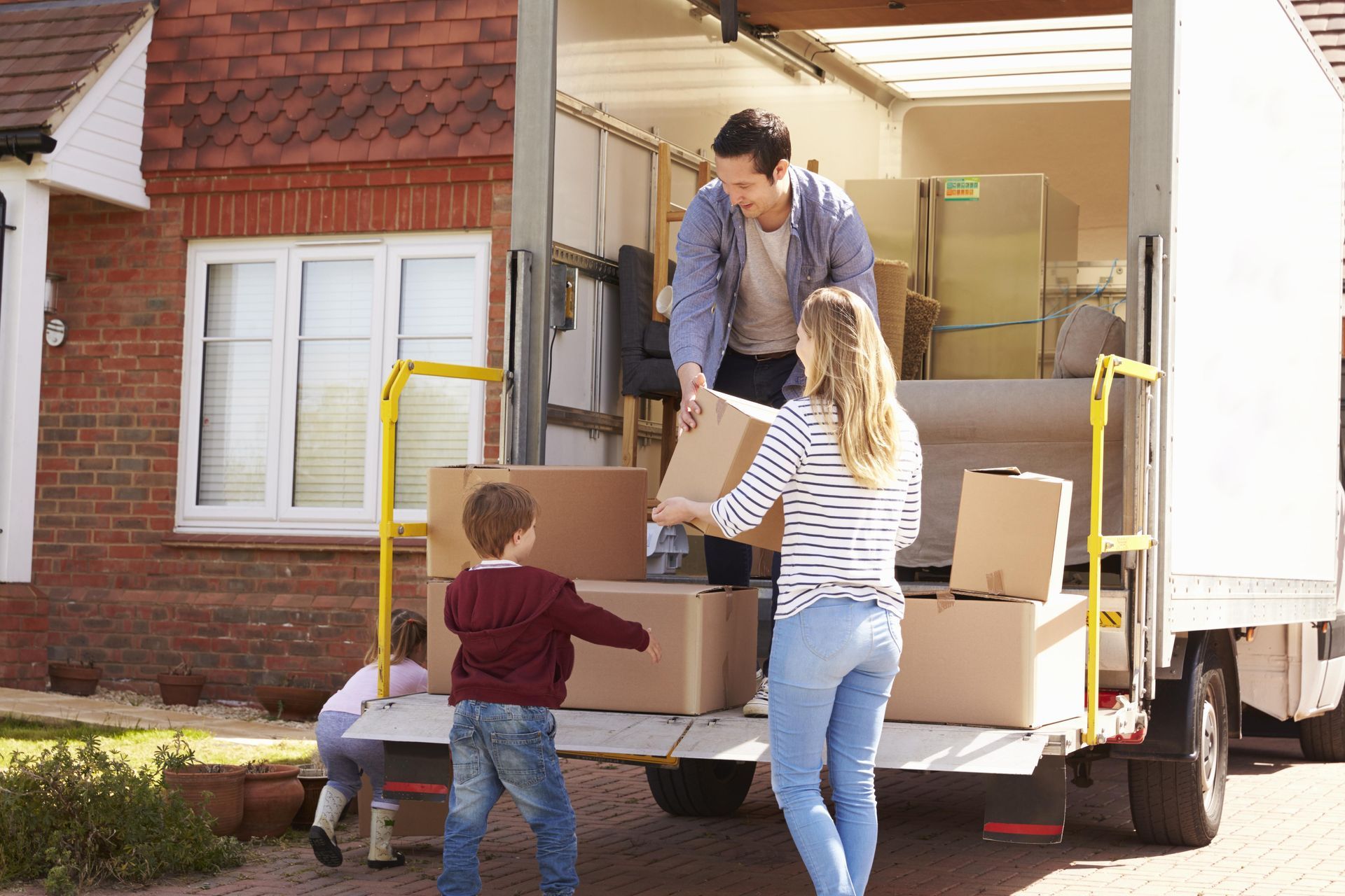 a family is loading boxes into a moving truck