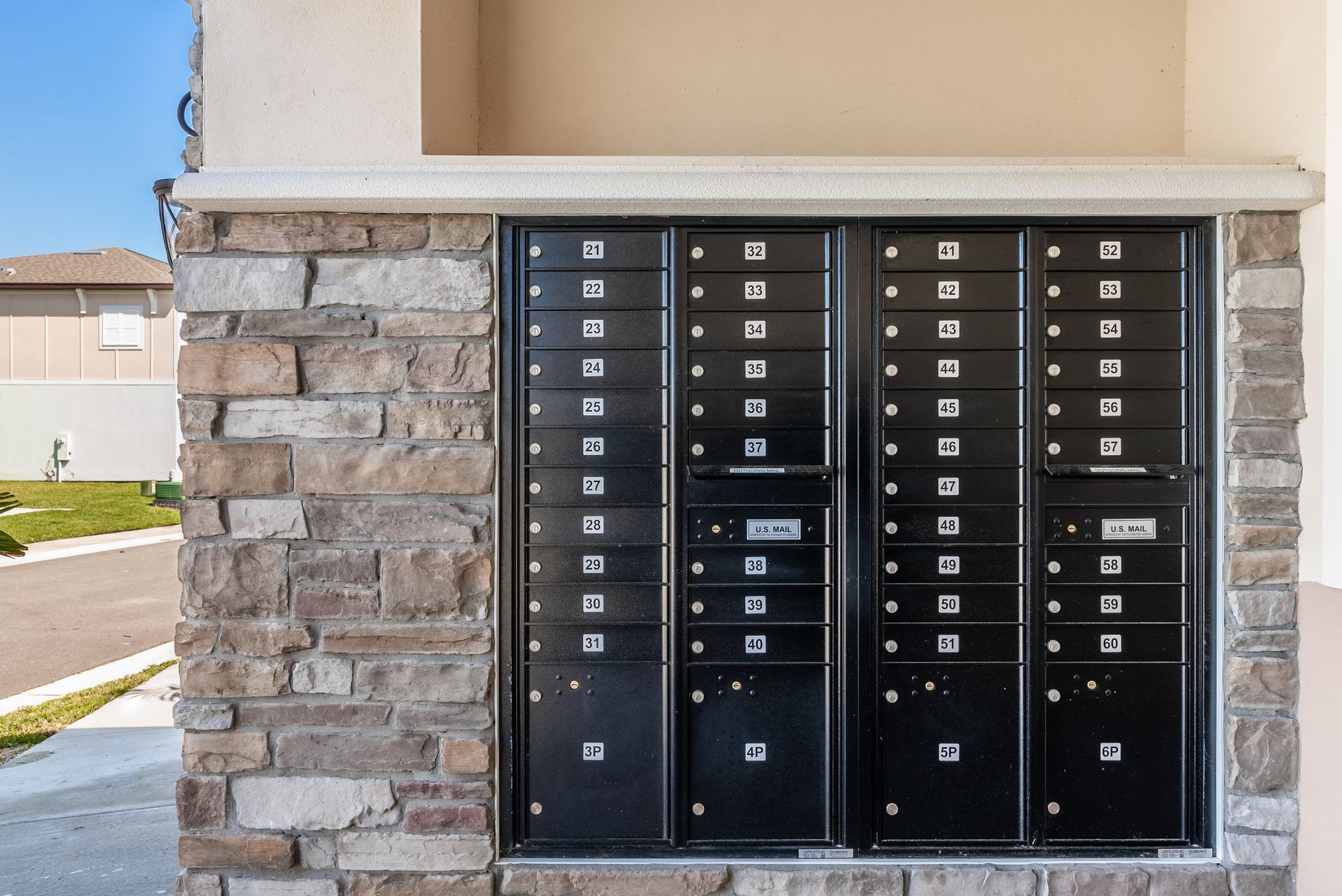 a brick wall with a bunch of mailboxes on it at Whitney Place Apartments in Clearwater, FL