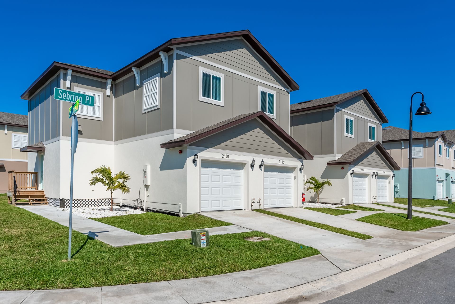 a row of apartment town homes in a residential area with a street light in front of them at Whitney Place Apartments in Clearwater, FL