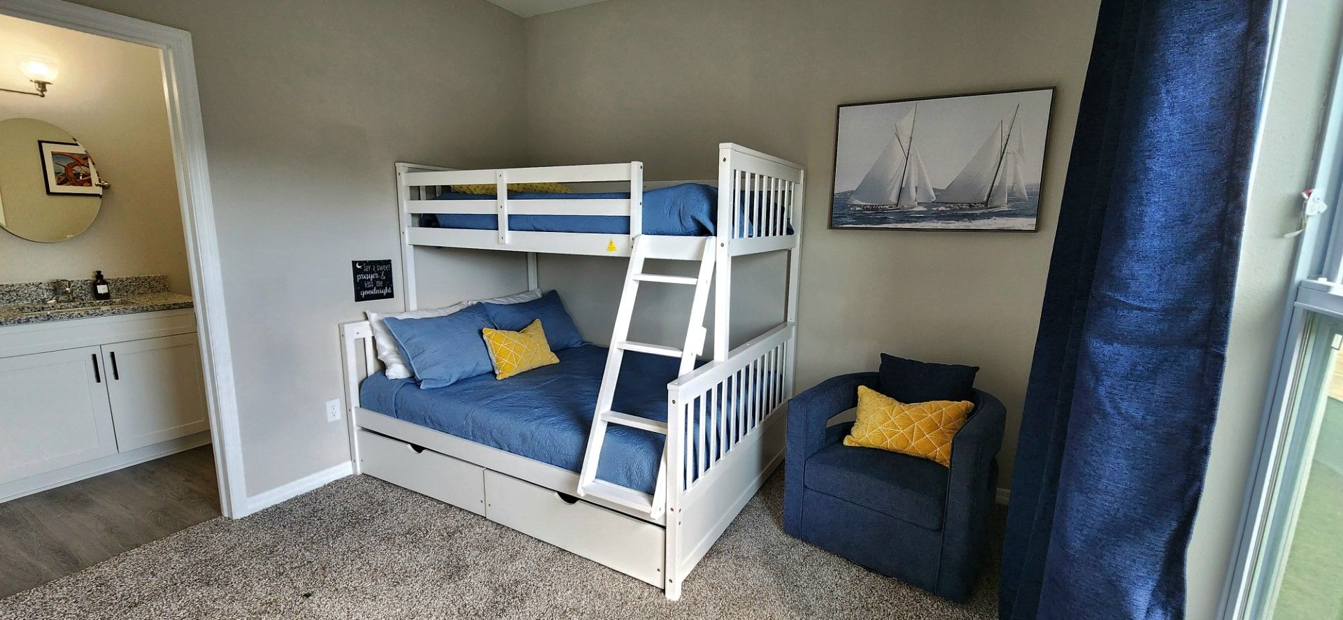 a bedroom with a bunk bed and a chair at Whitney Place Apartments in Clearwater, FL.