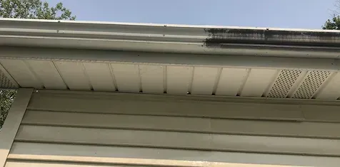 A before and after picture of a gutter cleaning job in Gloucester, VA