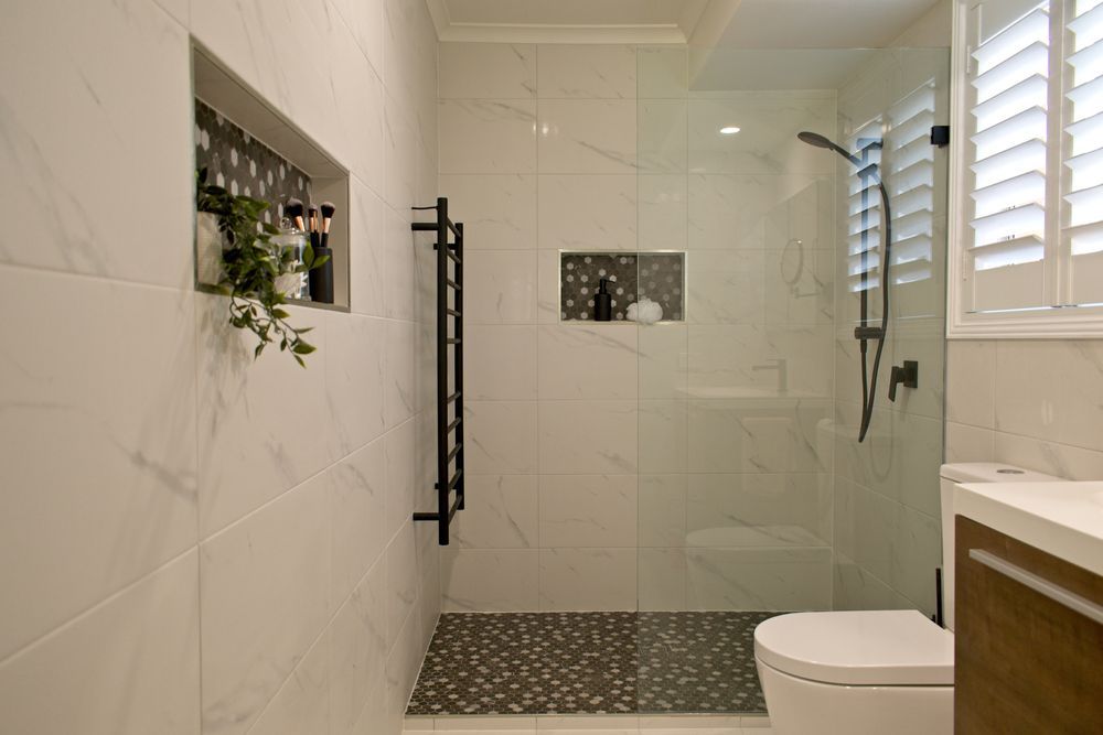 Modern Bathroom With White Marble Tile and Glass Shower — Local Glassmaster in Huskisson, NSW