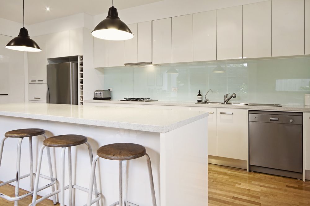 Modern White Kitchen With Island Stainless Steel and Splashback — Local Glassmaster in Huskisson, NSW