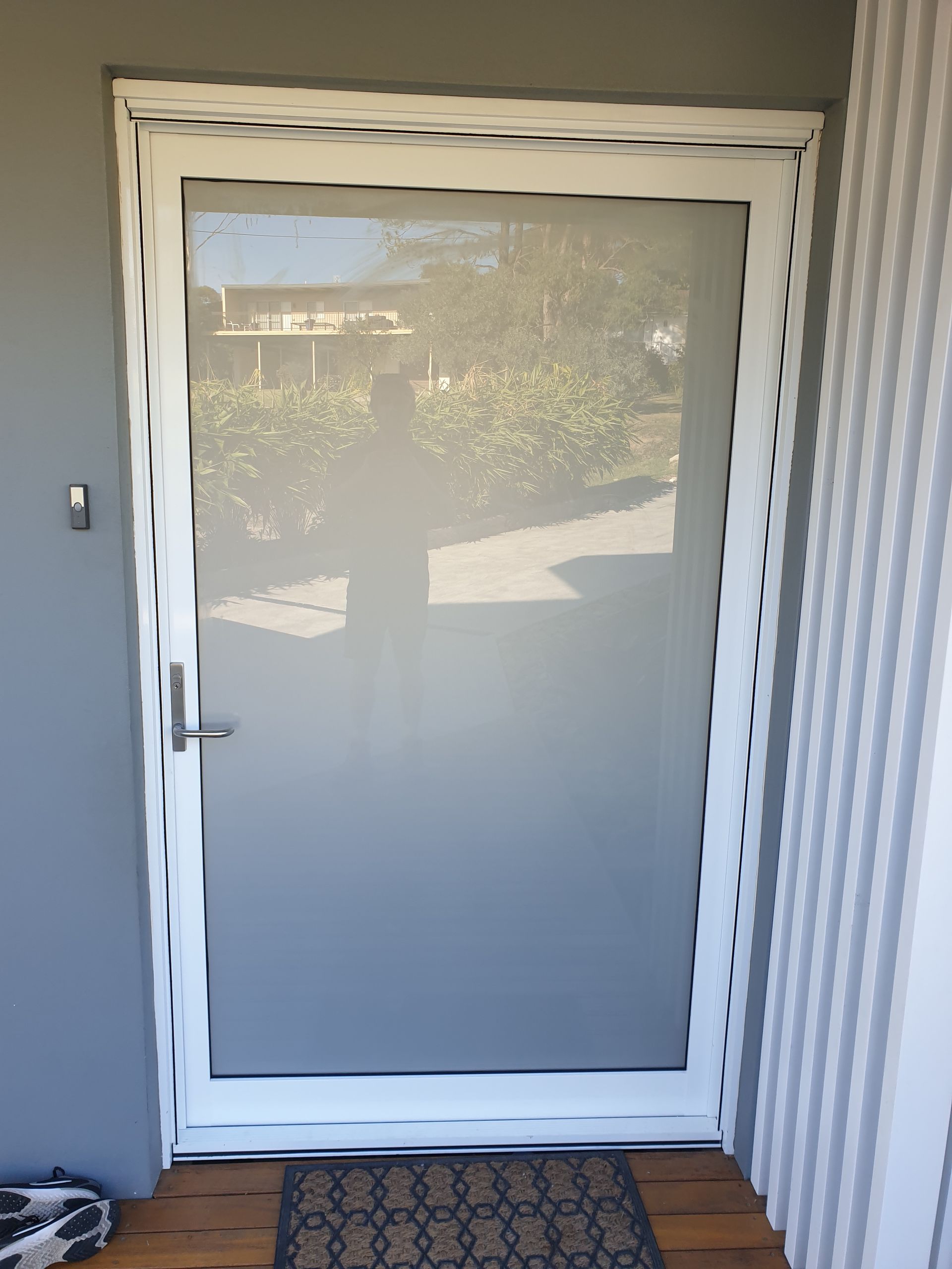 White Screen Door on a Wooden Porch — Local Glassmaster in Huskisson, NSW