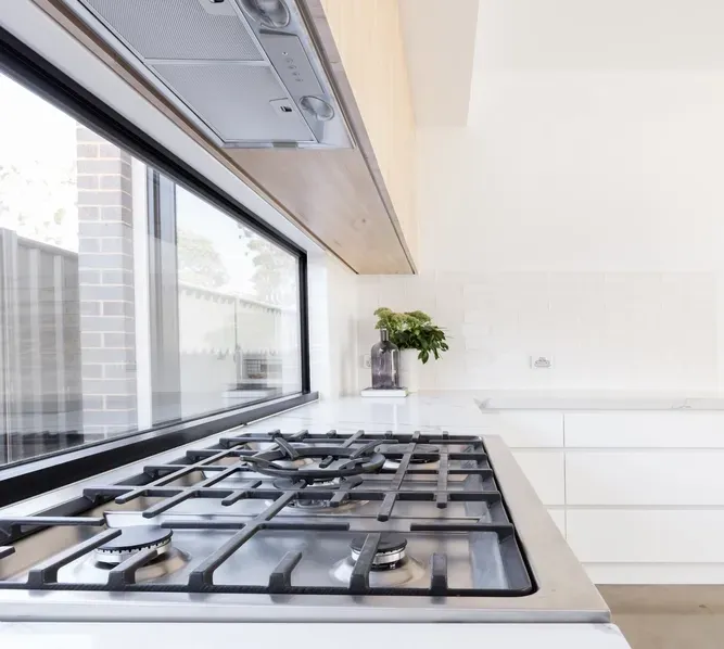 A Gas Cooktop With A Glass Splashback — Local Glassmaster in Huskisson, NSW