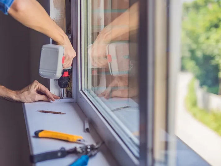 A Man Installing A Window Frame — Local Glassmaster in Huskisson, NSW