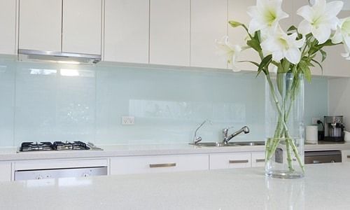 Modern White Kitchen with Light Blue Backsplash — Local Glassmaster in Huskisson, NSW