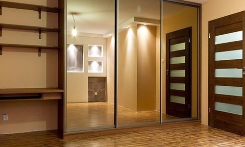 Bedroom with Mirrored Closet Doors Reflecting the Room — Local Glassmaster in Huskisson, NSW