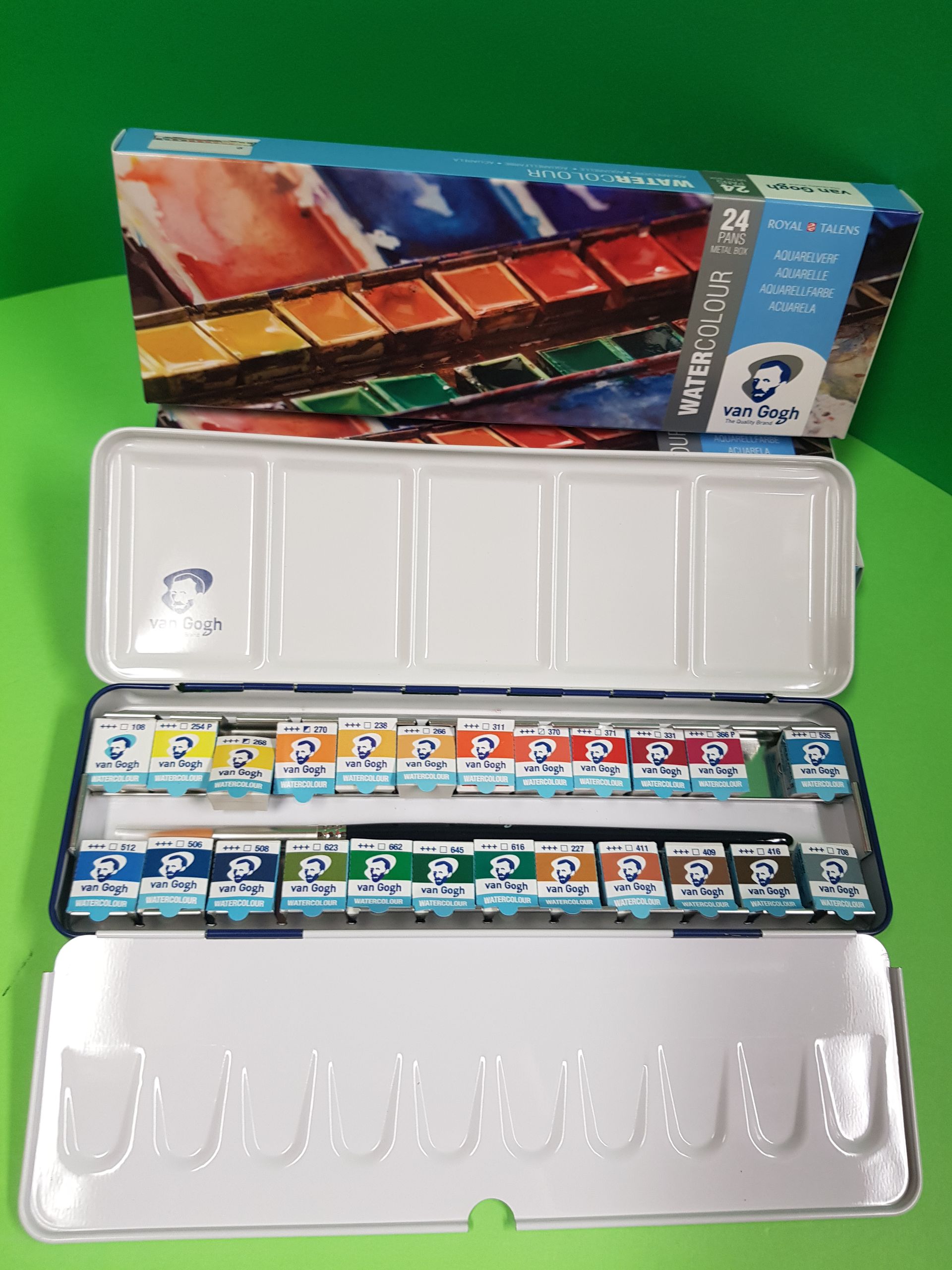 Set di acquerelli Van Gogh in una scatola di metallo, aperta su una superficie verde.
