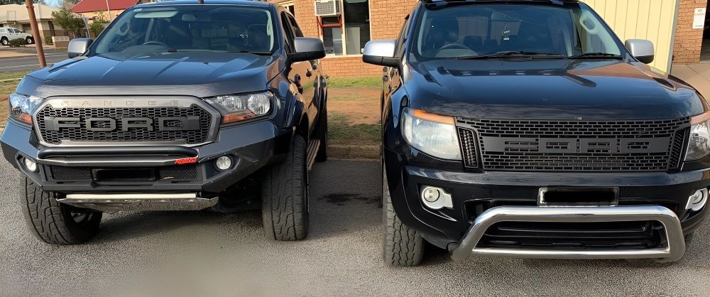Two Black Trucks Are Parked Next To Each Other In A Parking Lot — Tuned Suspension & Mechanic in Parkes, NSW