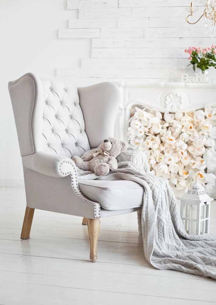 A White Chair With A Teddy Bear Sitting On It In A Living Room — Allwood Upholstery In Manunda, QLD