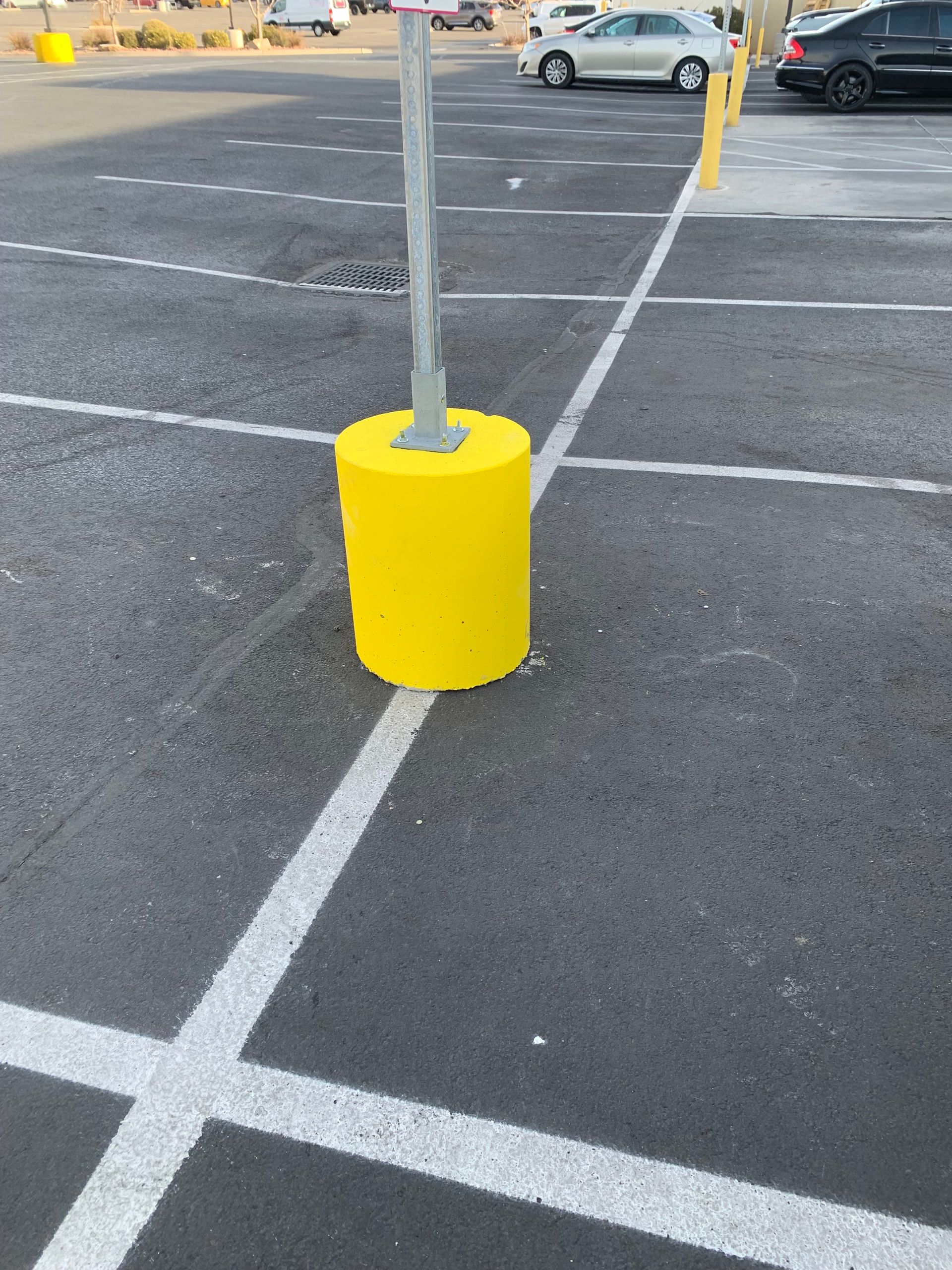 A concrete base with a metal post on top of it