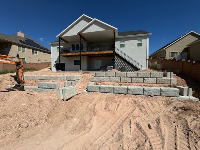 A concrete bench is sitting in the grass in a garden.