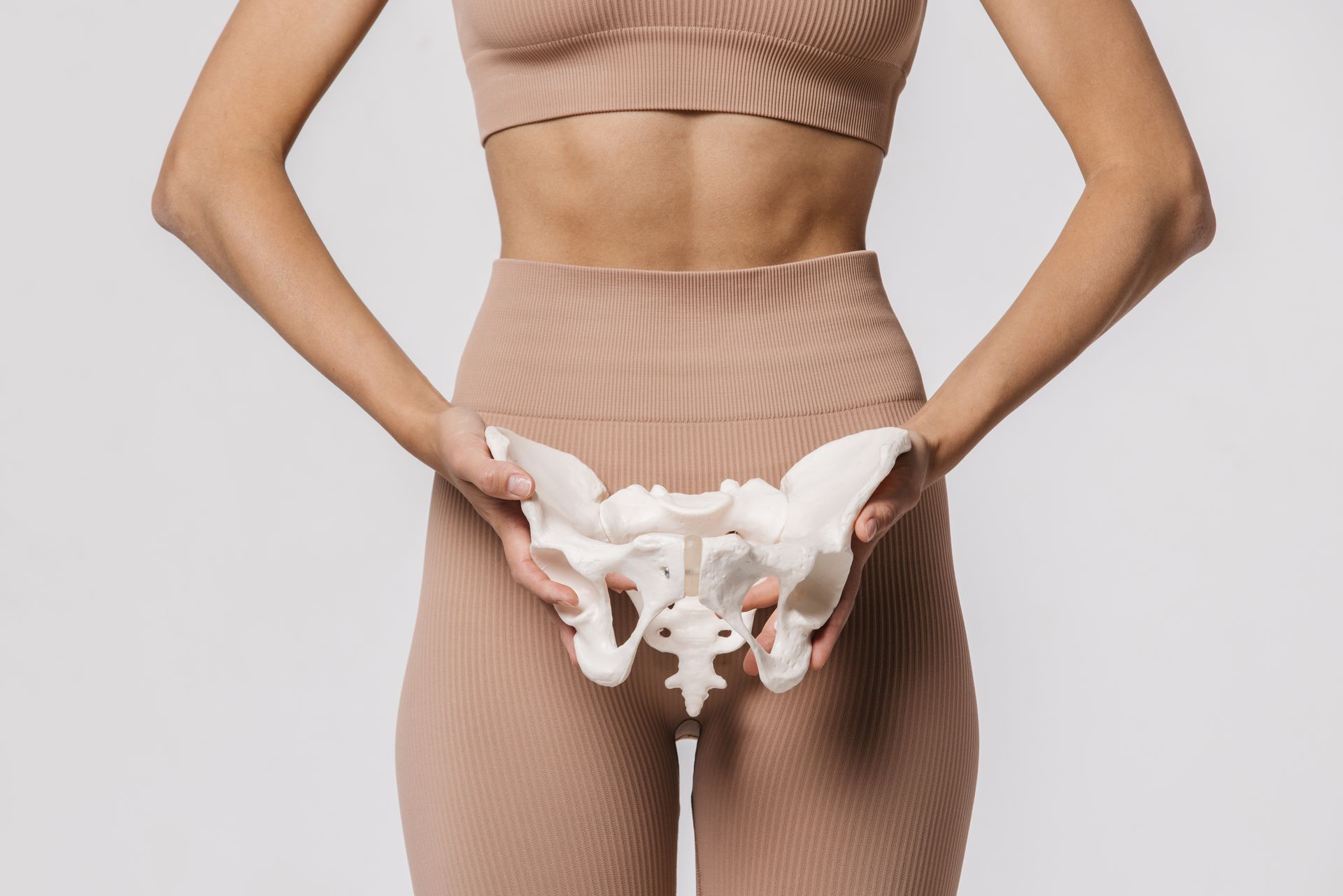 Woman holding a specimen of a pelvic bone