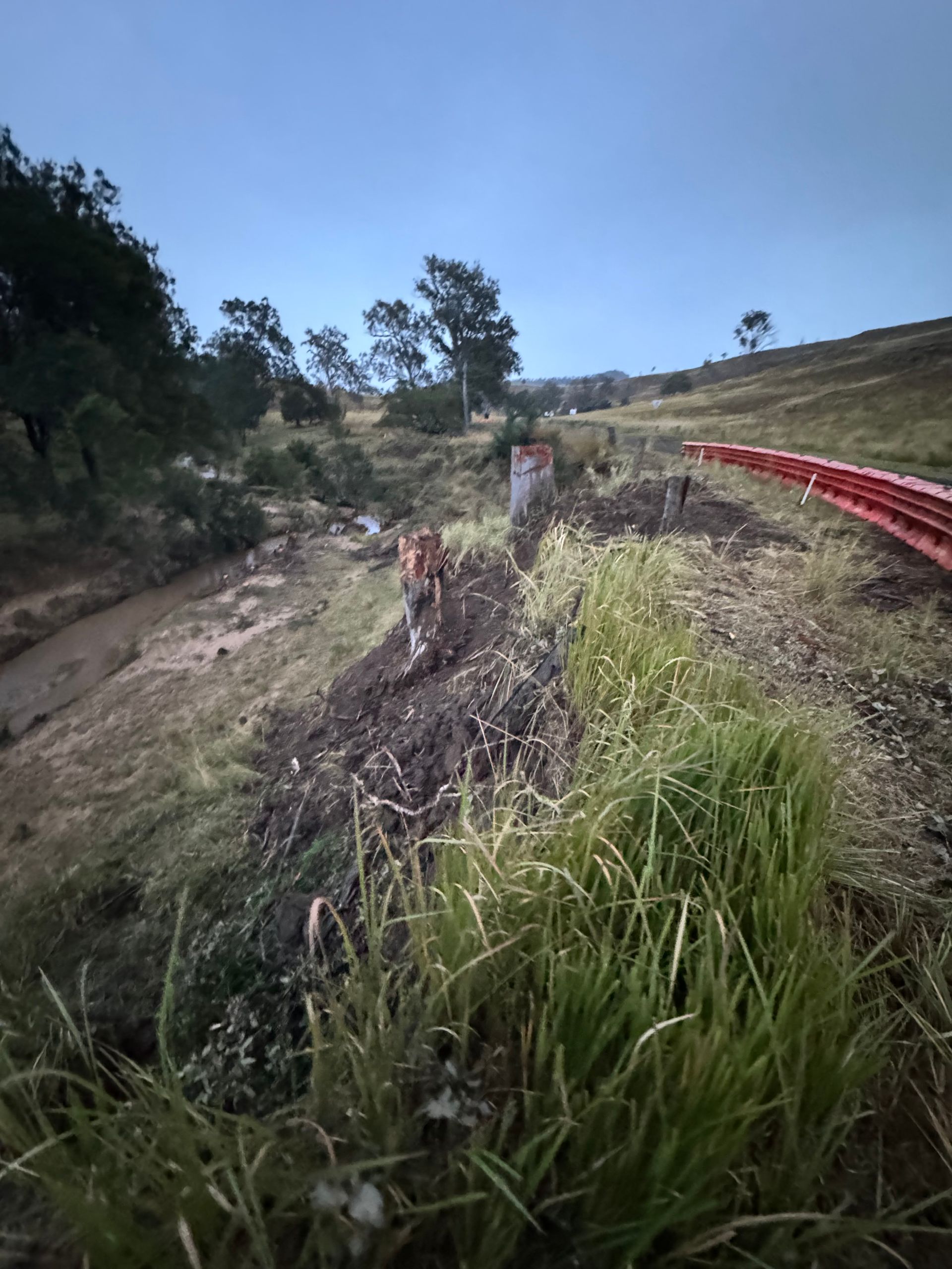 A damaged hillside that eroded down into a river bed soon to be repaired by spencer civil & earthworks.
