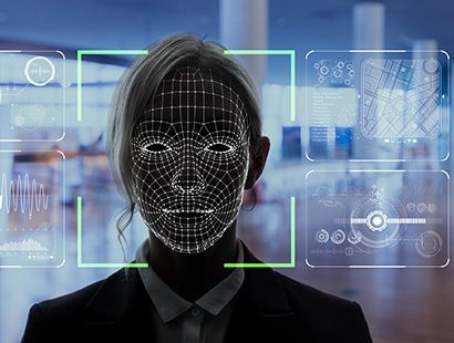 A woman 's face is being scanned by a facial recognition system.