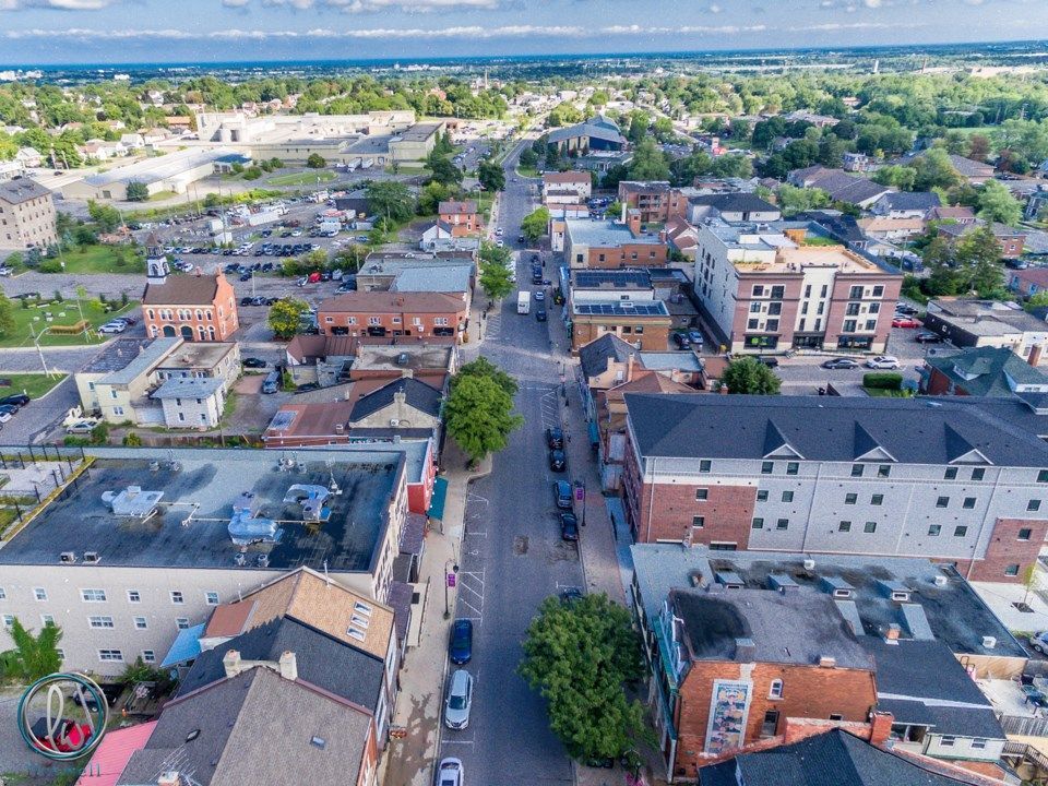 An aerial view of a small town with lots of buildings and trees.