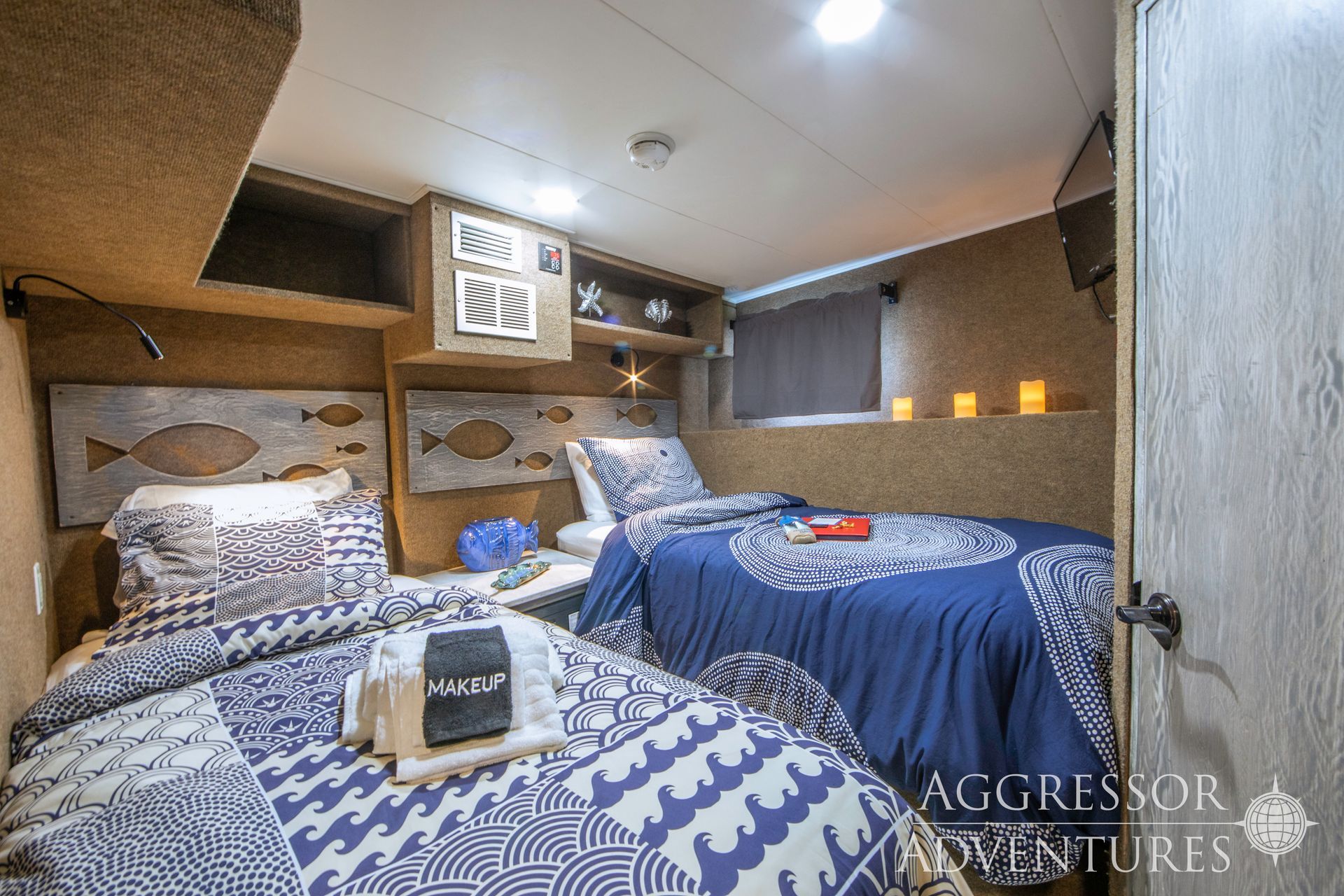Bedroom with canopy bed, towels, and a balcony overlooking greenery.