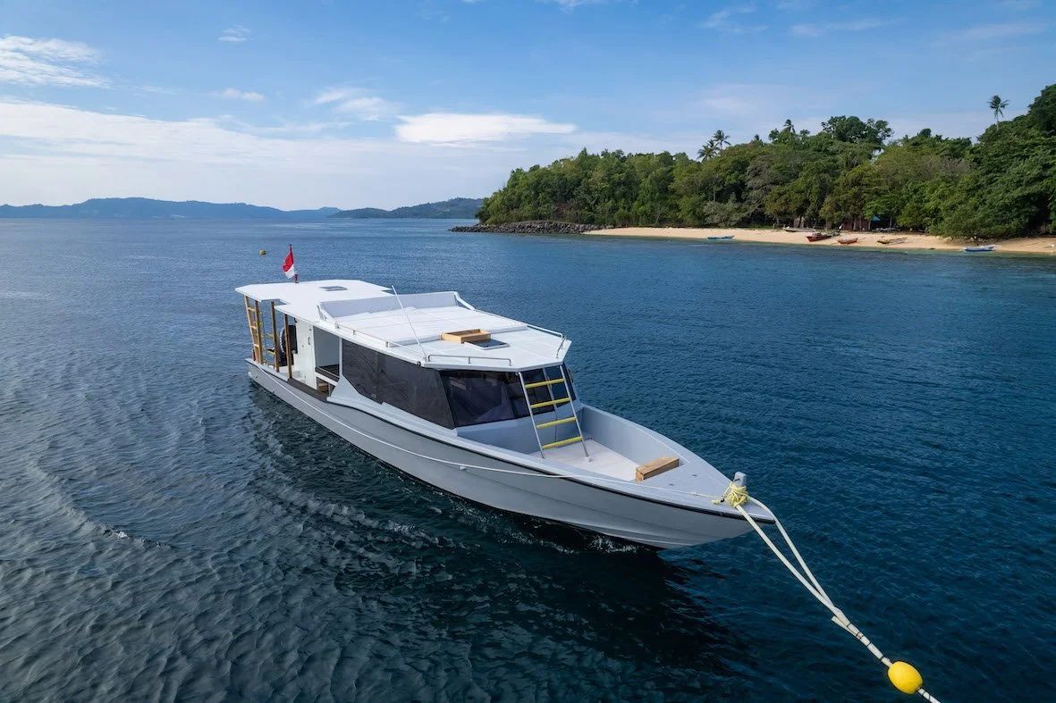Sunset view with curved seating area overlooking the ocean, orange and purple hues.