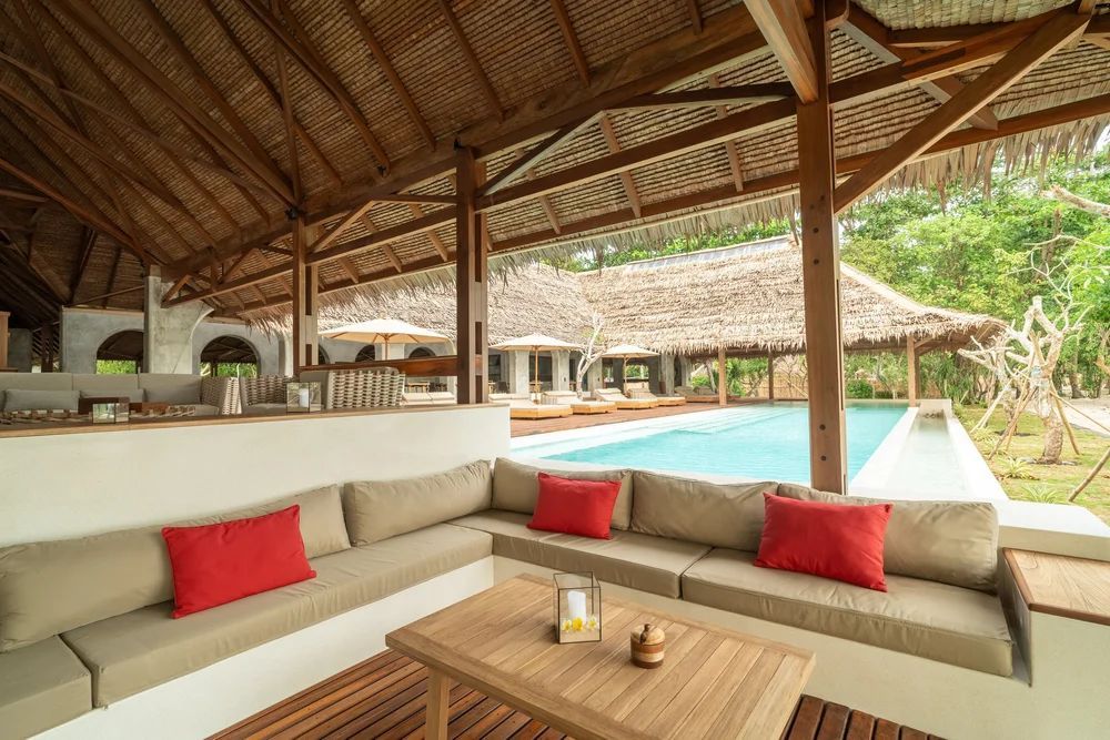 A colorful ornate ghost pipefish with spiky appendages against a dark background.